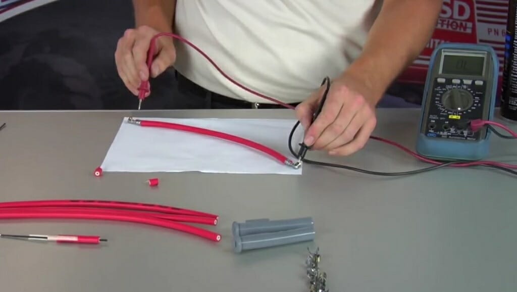 man checking the wire continuity using multimeter