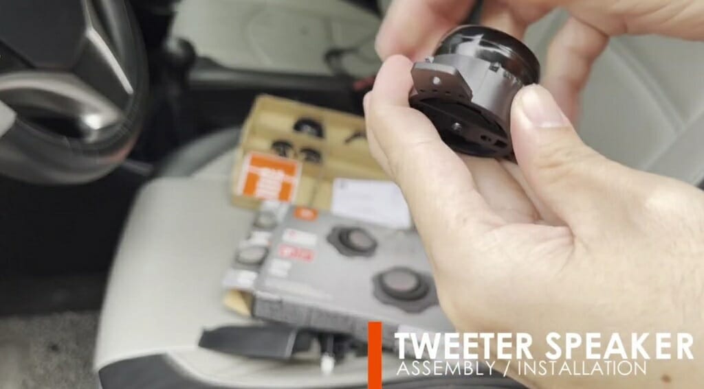 man connecting the tweeter to the flush mounting housing