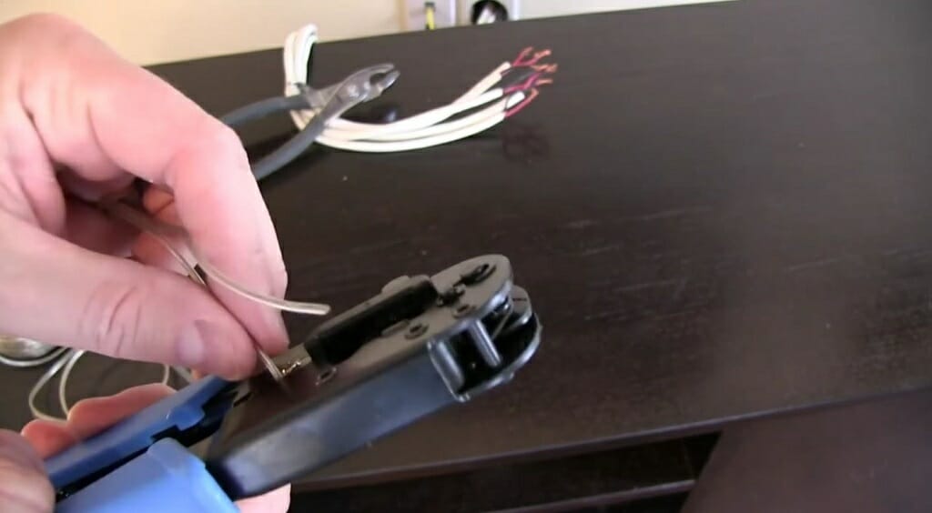 man inserting first wire into the wire stripper tool
