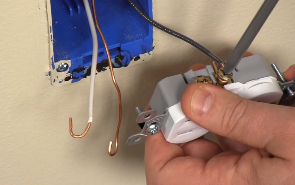 installing outlet wiring: screwing