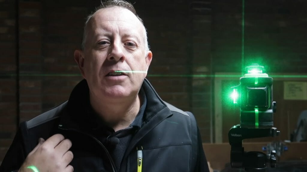 man besides a green laser level device