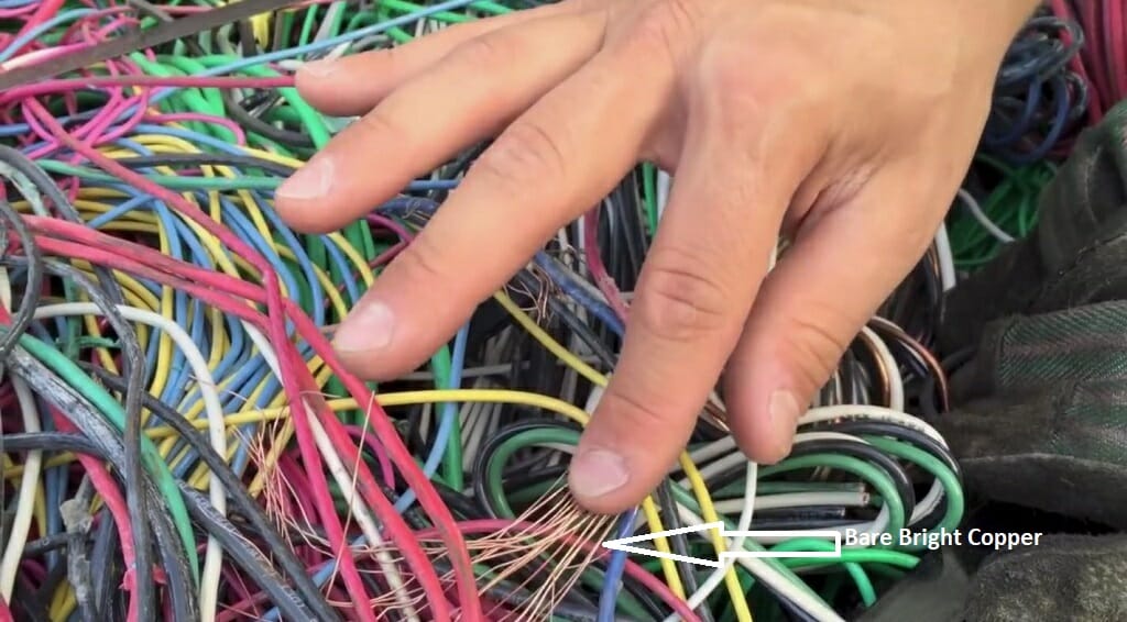 a man's hand touching tangled wires
