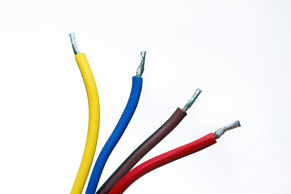 peeled end of yellow, blue, brown, and red cable wires