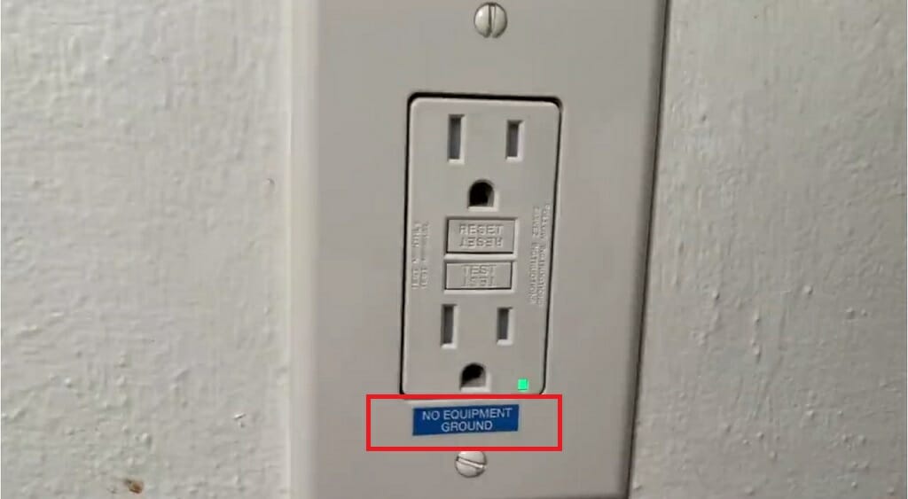 three prong outlet with "No Equipment Ground" label