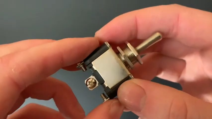 a pair of hand holding toggle switch
