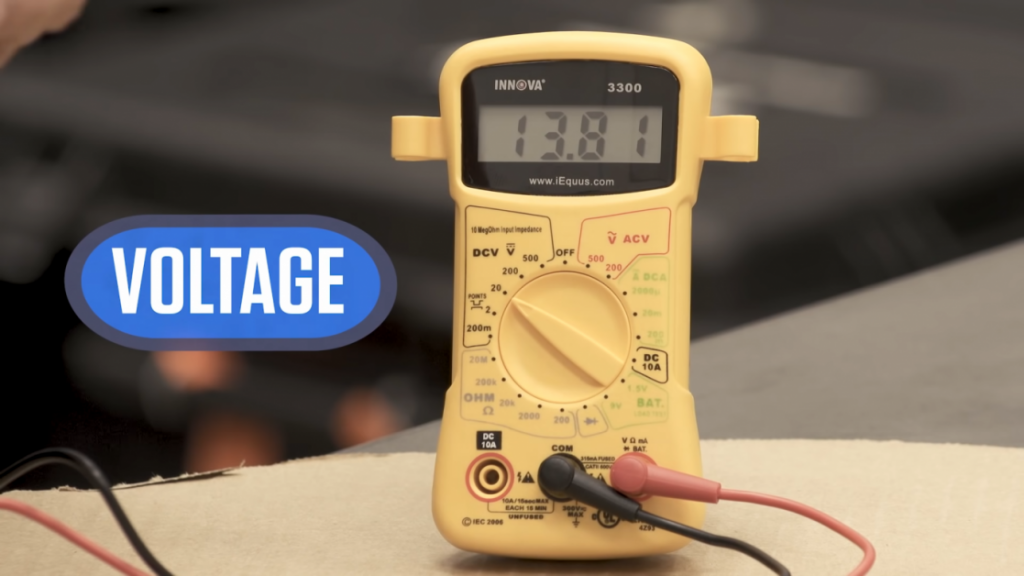 yellow multimeter at 13.81 voltage reading
