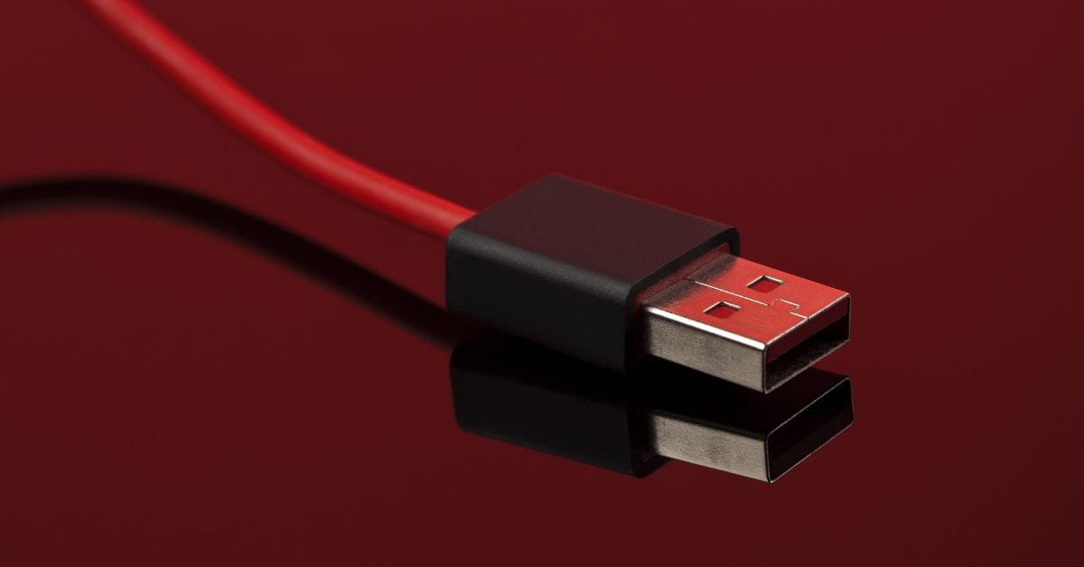 A red wire USB cable in a red table