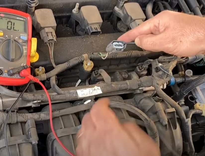 connecting the multimeter’s red test lead to the battery’s positive (+) terminal