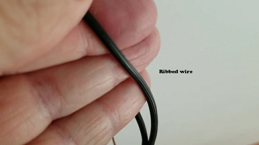 hand holding a ribbed wire