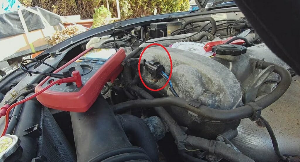 A multimeter and the oxygen sensor encircled in red