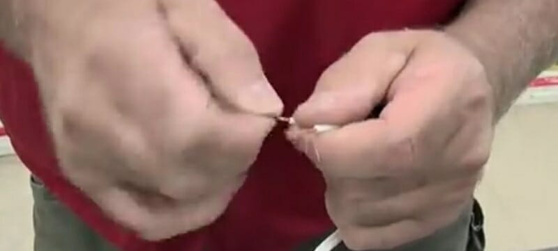 using index finger and thumb to twist the strands together