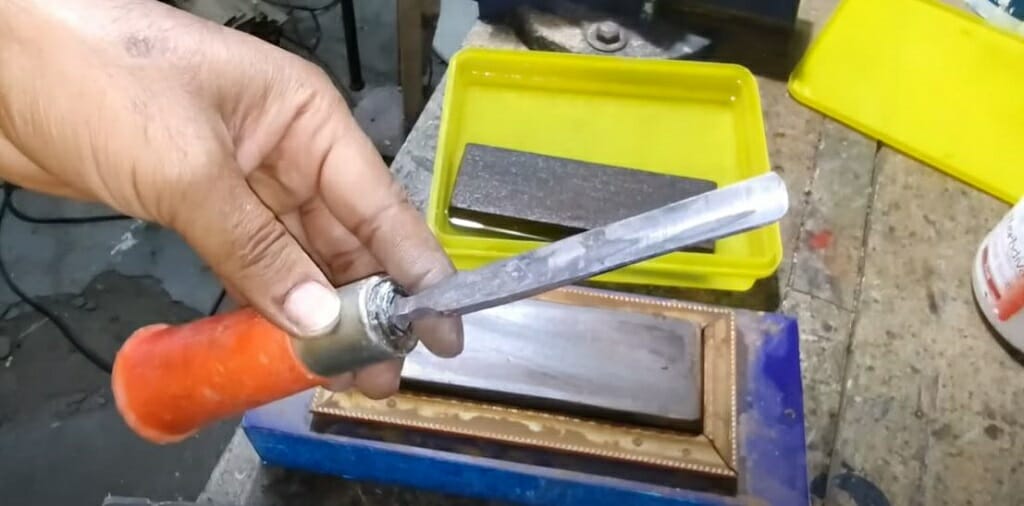 A person holding a chisel