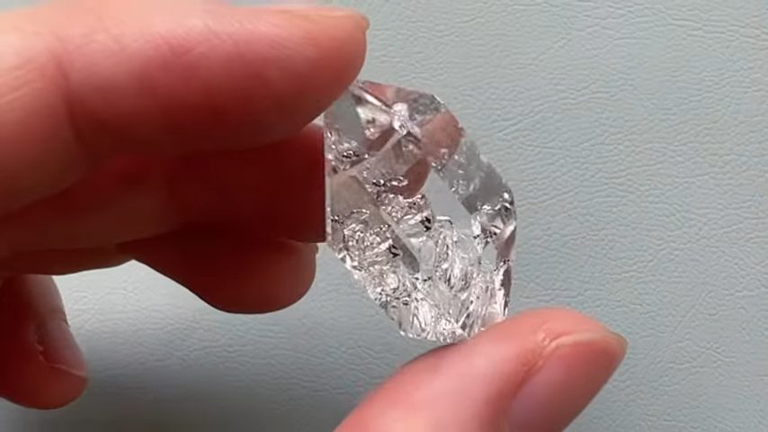 hand holding a piece of diamond