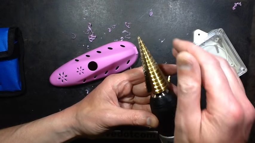 step drill bit cutting holes on plastic