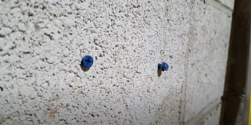two tapcon screw on the wall