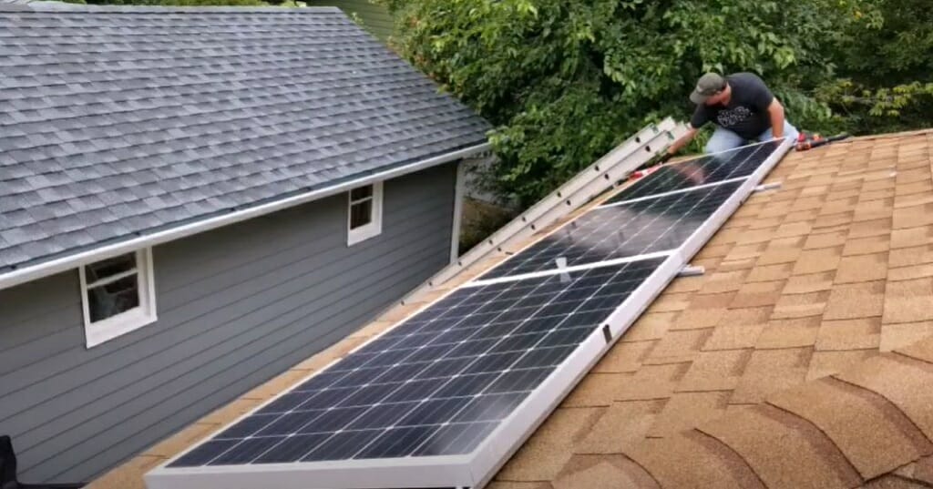 man installing solar panel at the rooftop