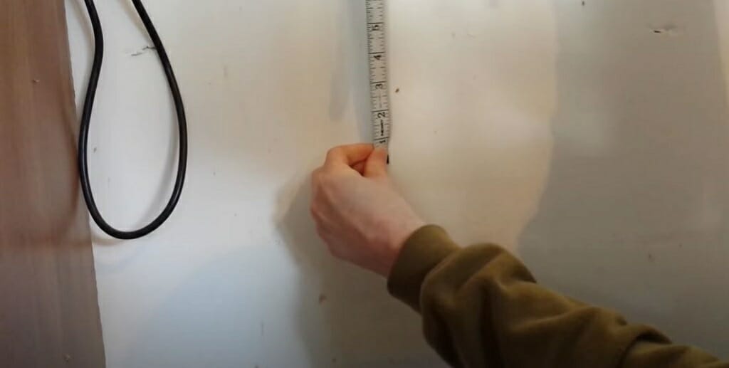 measuring wall with tape measure