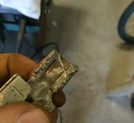 mechanic holding a Bad battery current sensor