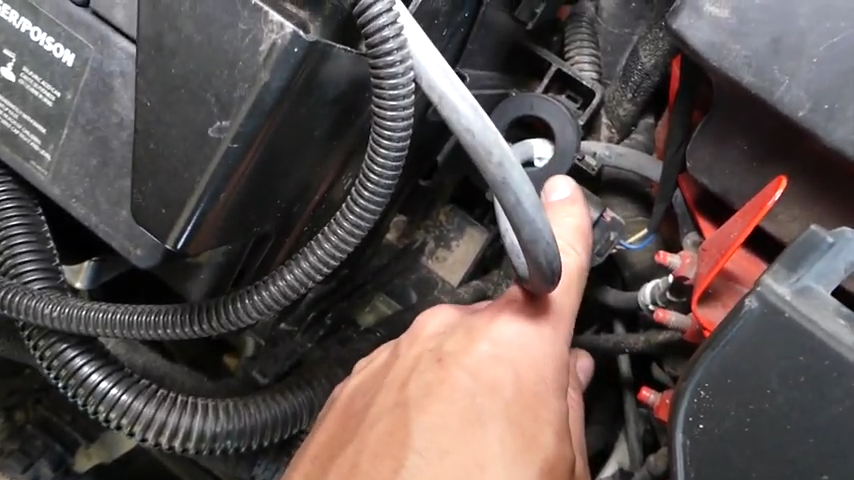 A mechanic pointing at the battery sensor