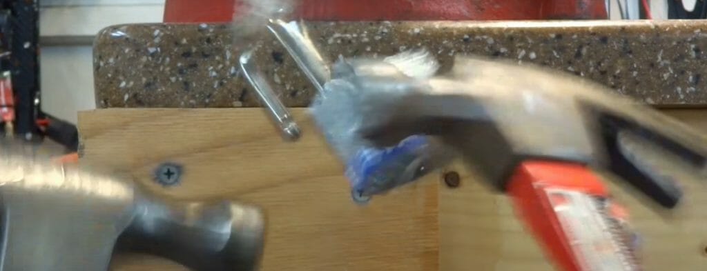 tapping the side of the lock with a hammer