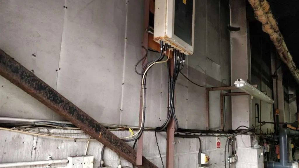 asbestos insulation boards behind wiring