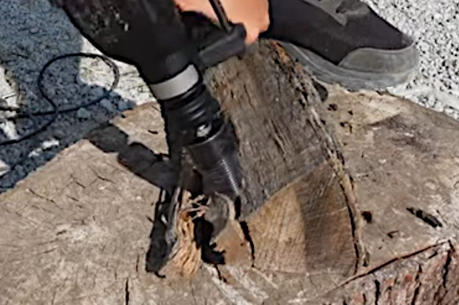 drilling into firewood using a hammer drill