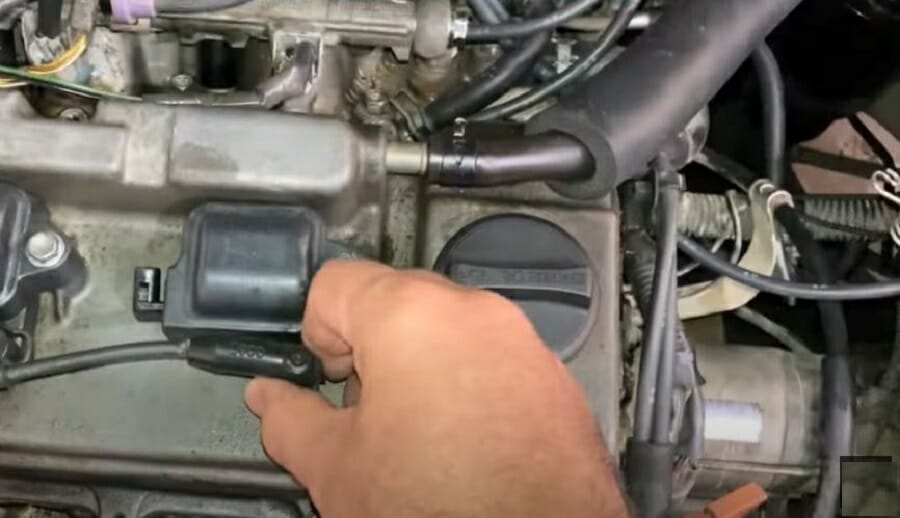 hand holding en engine coil ignition