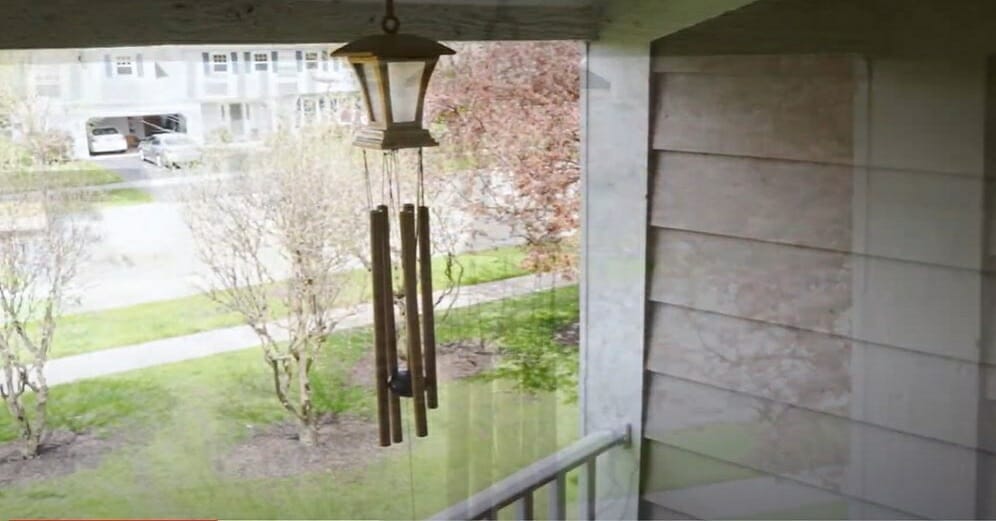hanging the wind chime on a tall lantern