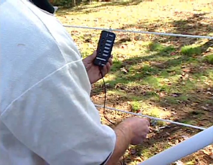 man installing electrical fence