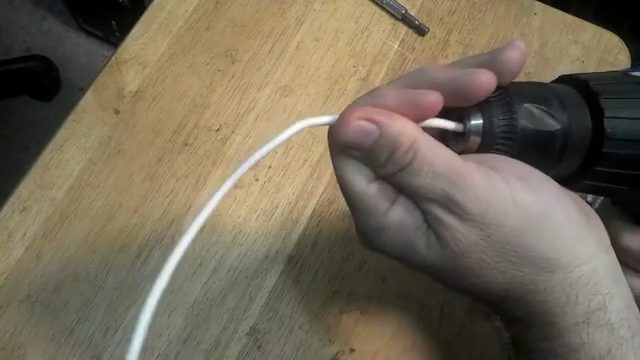 pulling the wire wrapped around the screwdriver