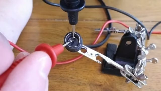 red and black multimeter probe into the coaxial wire