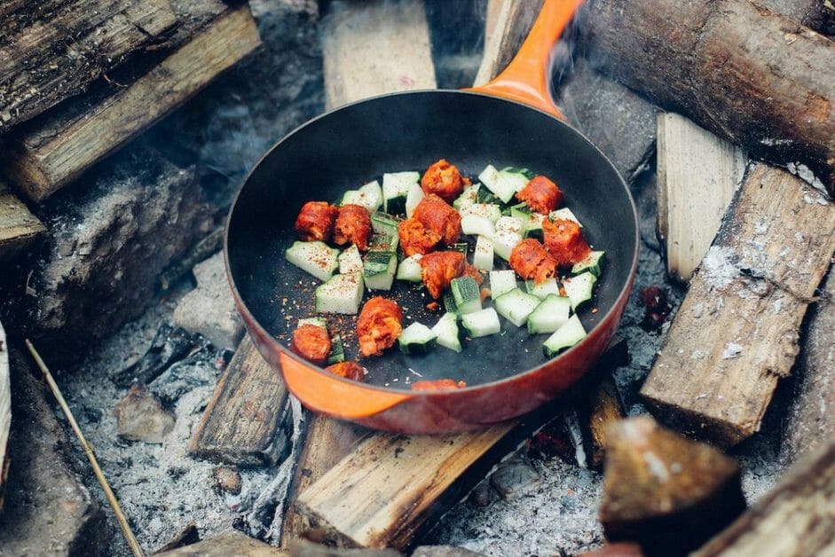 cooking in a skillet over a fire pit