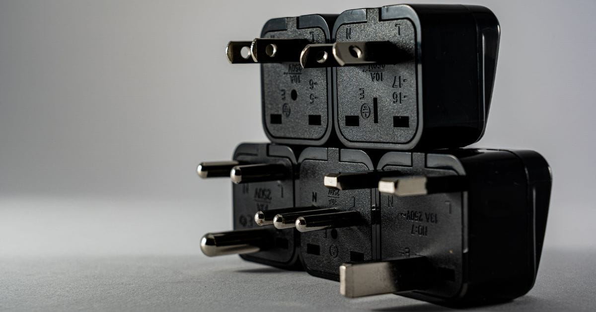 A 5 3-prong plug in a gray background