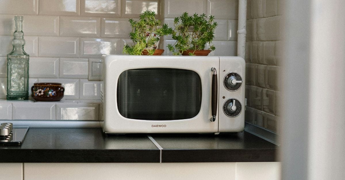 A Daewoo microwave oven on a kitchen sink