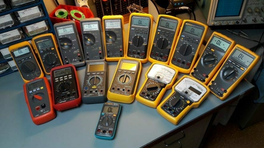 A group of multimeters at a table