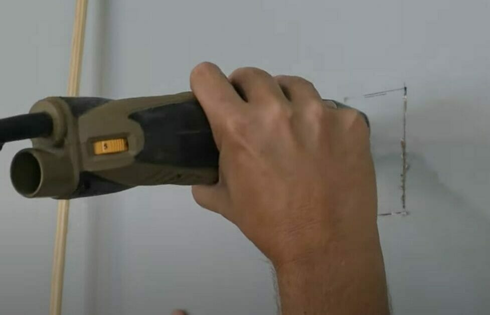 cut the drywall along the outline you made for the outlet