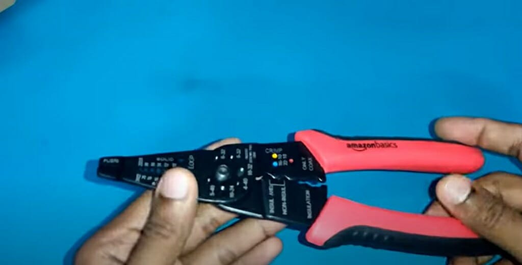 man's hand holding a plier