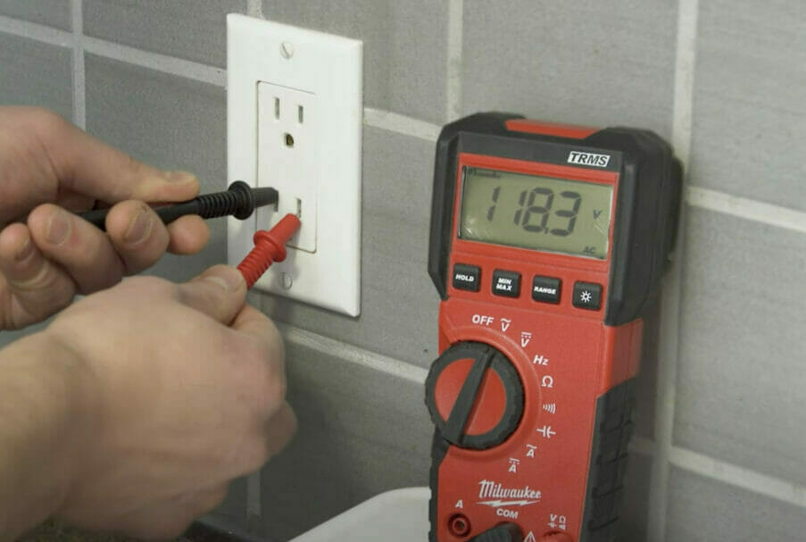 multimeter probes on outlet testing
