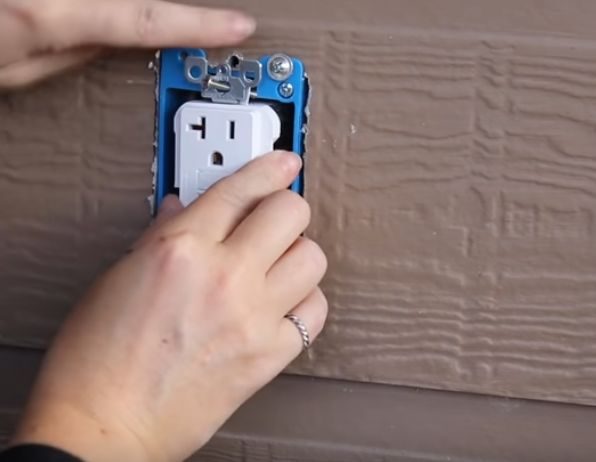 inserting the outlet receptacle into the blue box