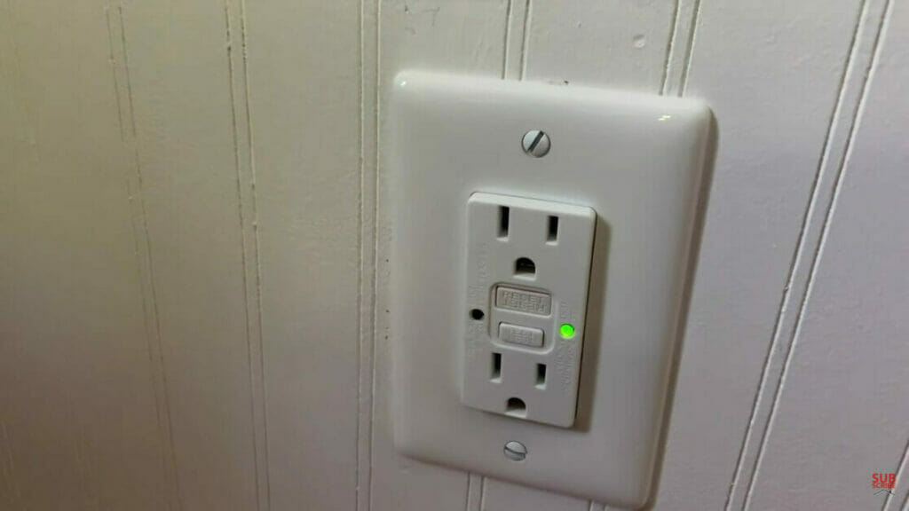 a wall outlet with green light on