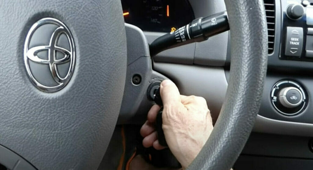 hand turning on a car