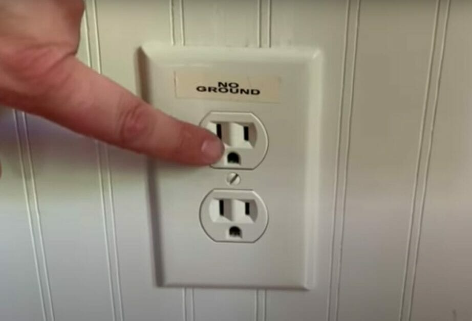 man pointing on a no ground outlet