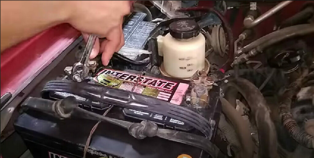 removing the battery from the hood