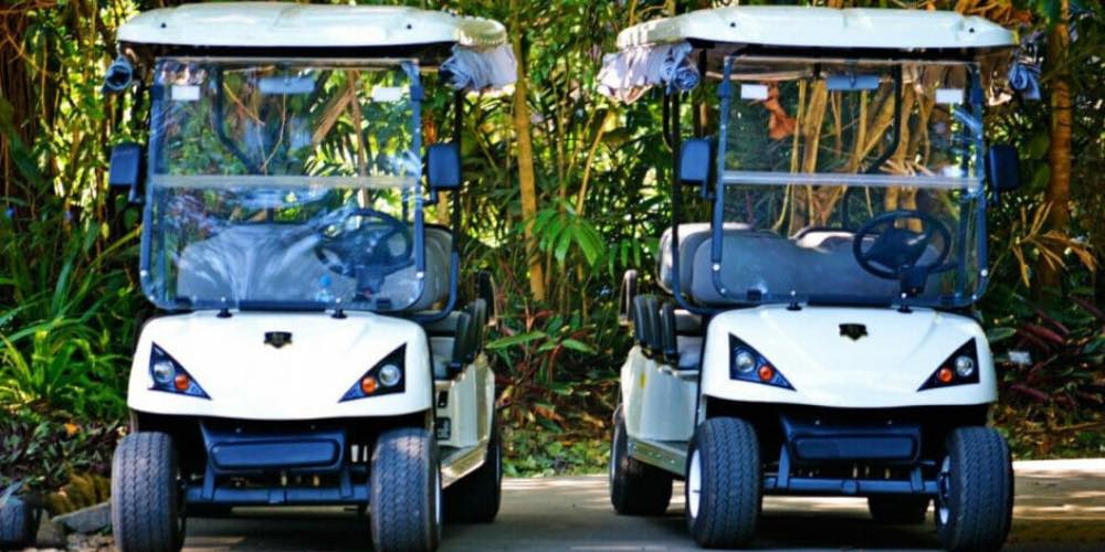 two golf carts parked