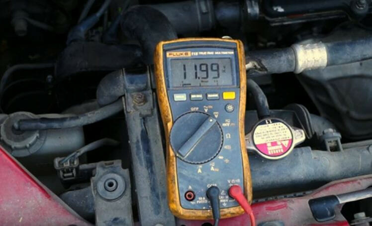 11.99 reading on a yellow multimeter
