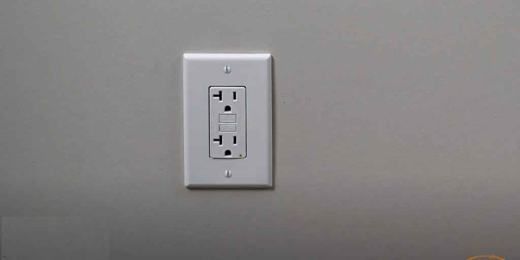 a matte silver outlet in a flat gray silvery wall