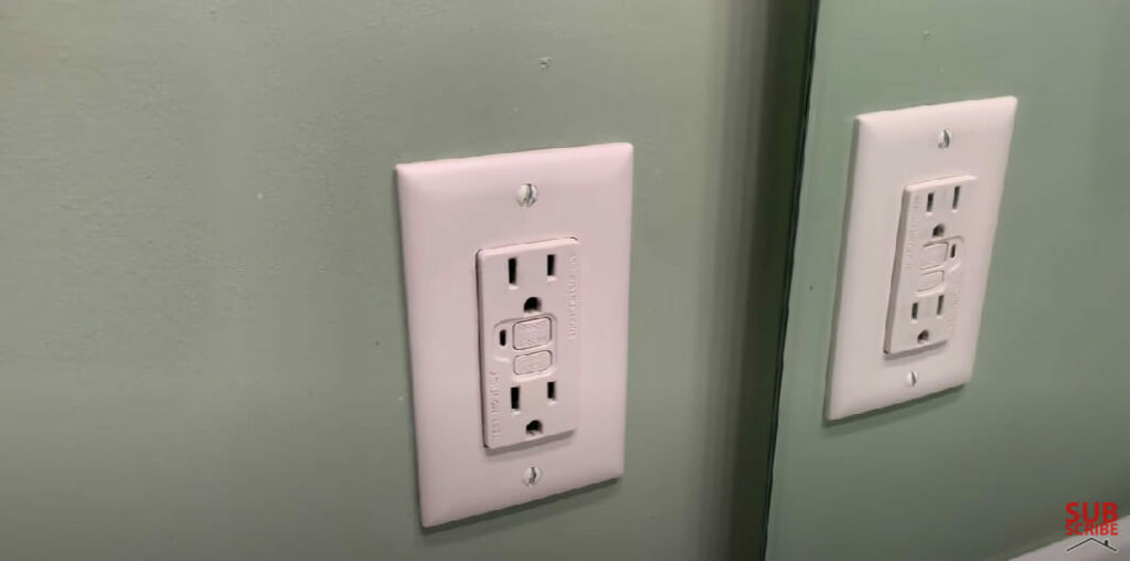 a mirror image of a GFCI outlet in the bathroom
