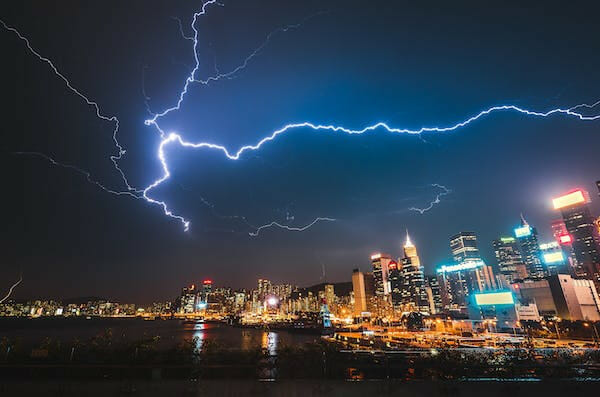 a picture of lightning above city lights