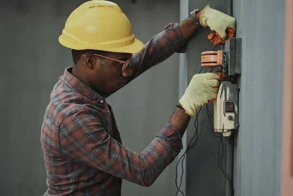 an electrical engineer working on wall outlet box