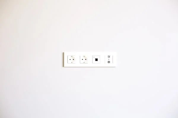an outlet on a white wall